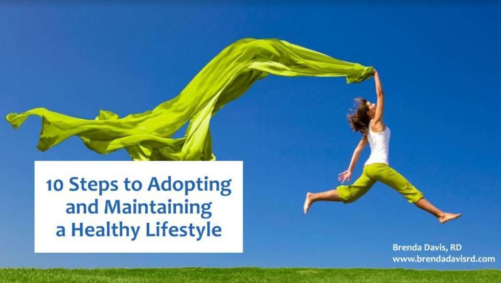 A person joyfully leaping in the air, holding a flowing green fabric against a clear blue sky. Text on the image reads, 10 Steps to Adopting and Maintaining a Healthy Lifestyle with Tips from a Top Dietitian with a website link.